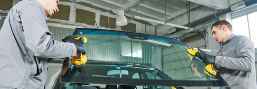 Two technicians performing auto glass services